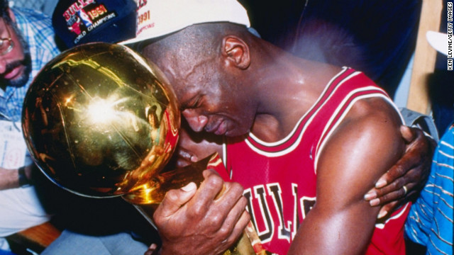 Michael Jordan of the Chicago Bulls hugs the NBA Championship Trophy after the Bulls defeated the Los Angeles Lakers 4 games to 1 to win the NBA Finals on June 12, 1991, at the Great Western Forum in Inglewood, California.