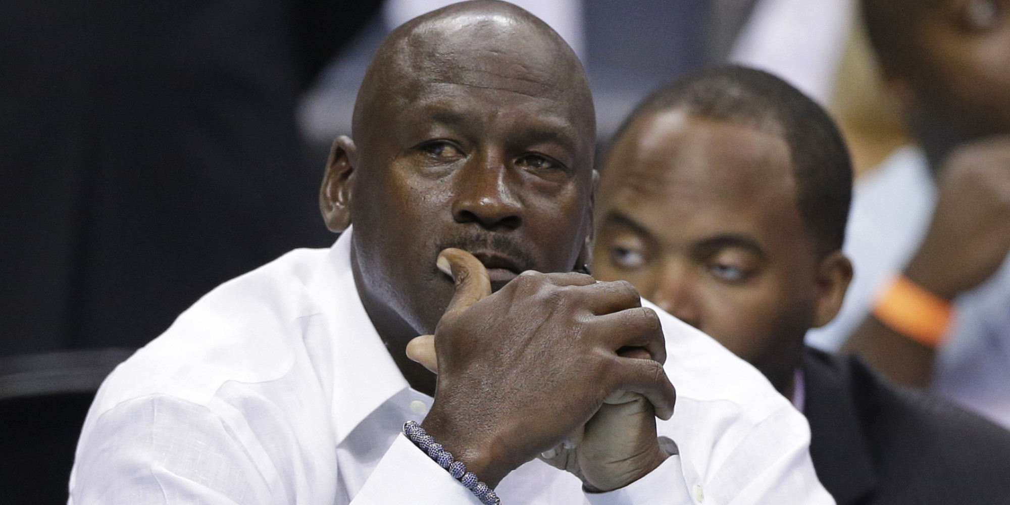 Charlotte Bobcats owner Michael Jordan watches the action during the first half in Game 3 of an opening-round NBA basketball playoff series against the Miami Heat in Charlotte, N.C., Saturday, April 26, 2014. (AP Photo/Chuck Burton)