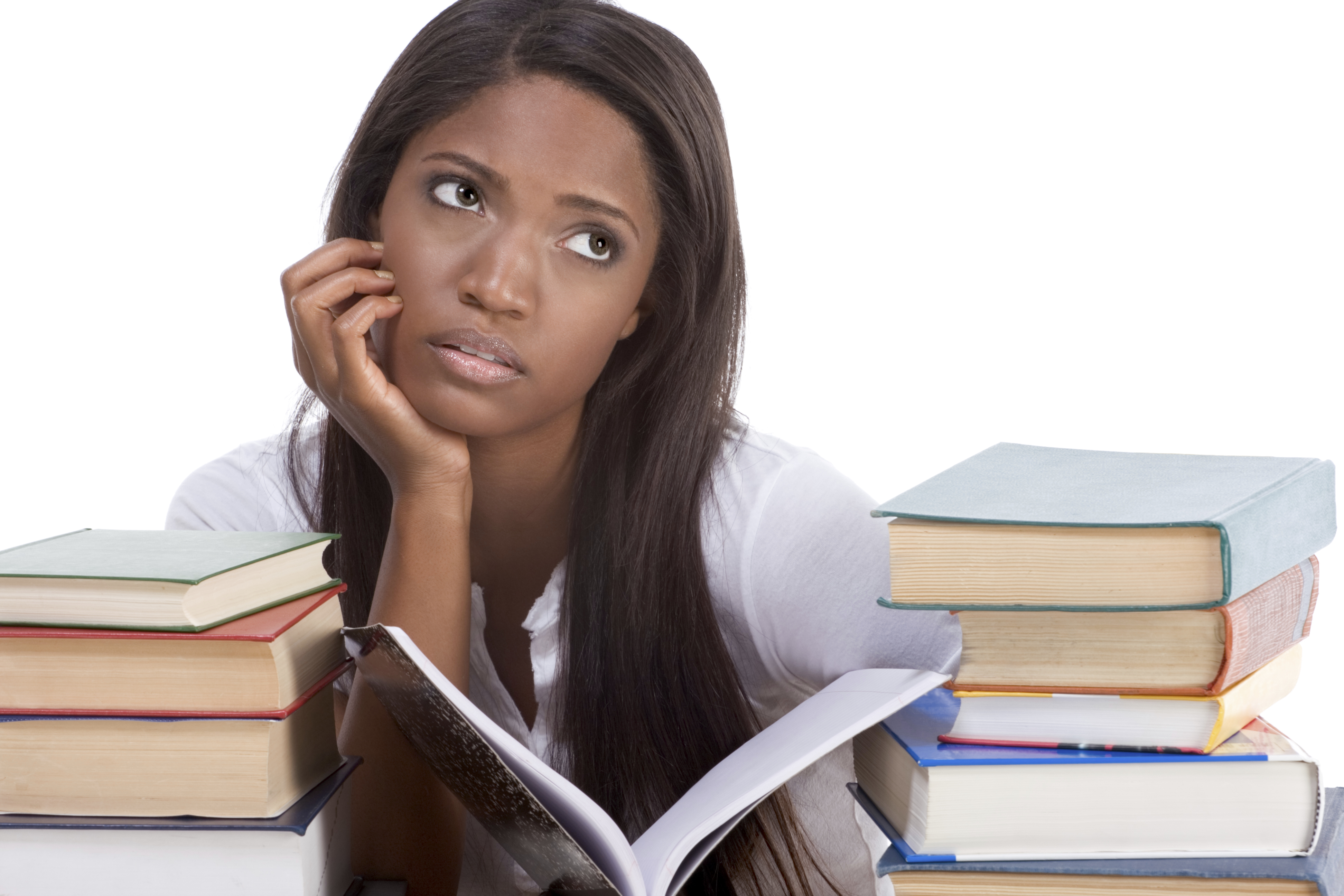 High school or college ethnic African-American female student sitting by the desk with lot of books in class or library and doing homework