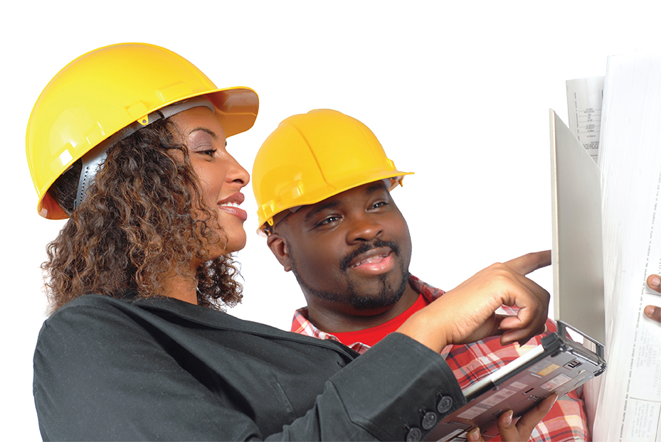 Female architect and construction worker looking at laptop together