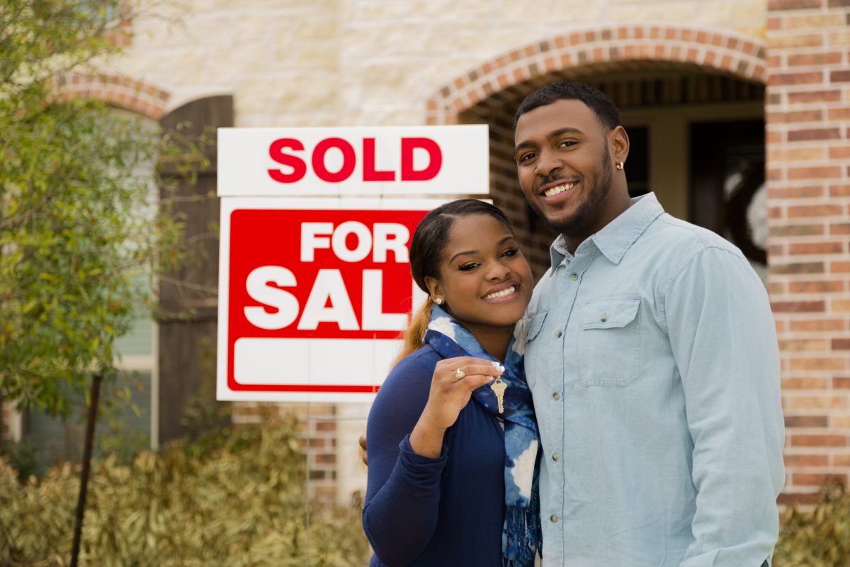 Real Estate: African descent couple buys first home. House key.