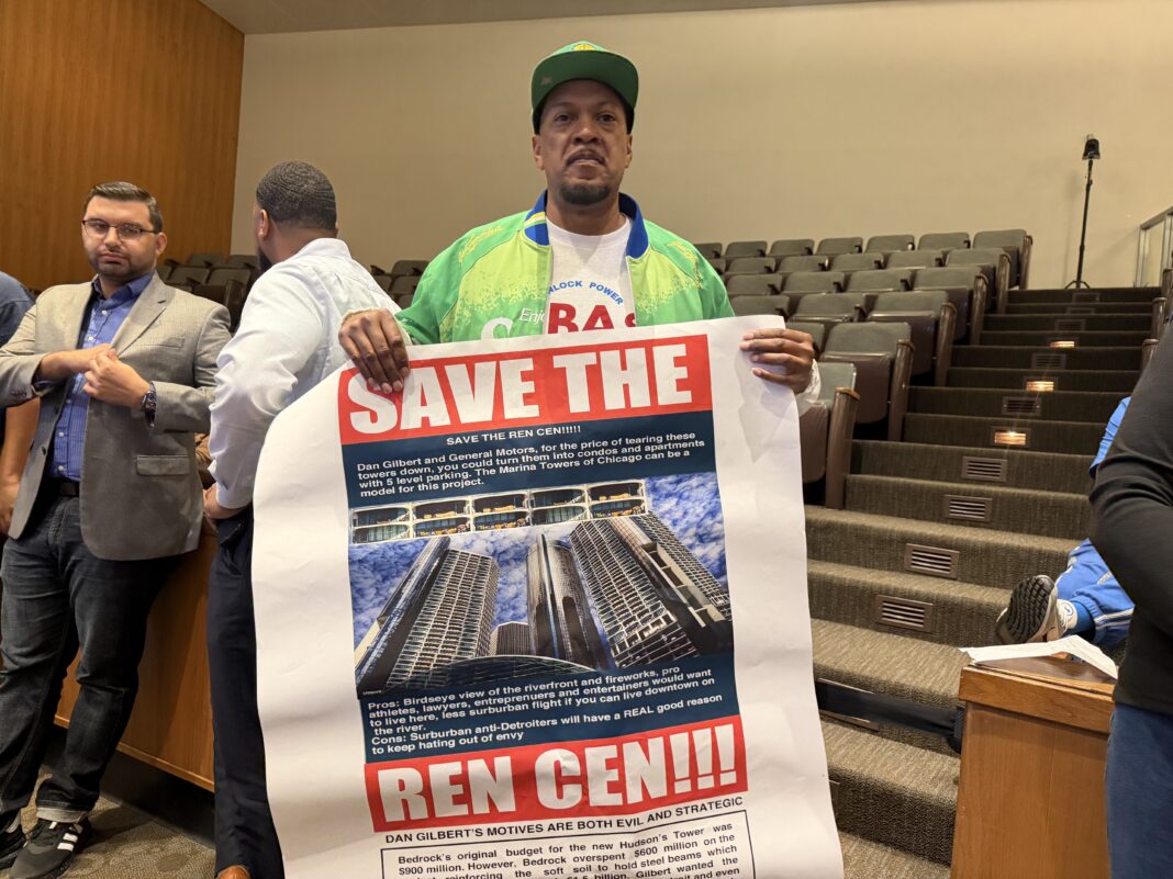 Dwayne Hoffman holds a sign that reads, 